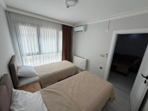 a hotel room with two beds and a window at Atlas Suite Trabzon in Trabzon