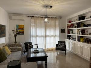 a living room with a couch and a table at Casa Los Barberos in Valle de Abdalagís