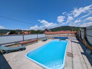 a swimming pool on the roof of a house at Pensiunea Teona in Târgu Ocna