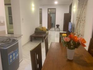 a living room with a table with a vase of flowers on it at Airport Transit Home in Ja-Ela