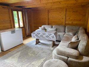 a living room with a couch and a table at The Meridian in Valbonë