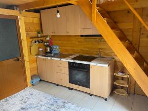 a kitchen with a stove top oven in a room at The Meridian in Valbonë
