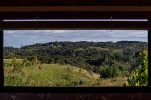 a view of a hill from a window at Tiny House - Rancho Queimado SC - 15 Min do centro in Rancho Queimado