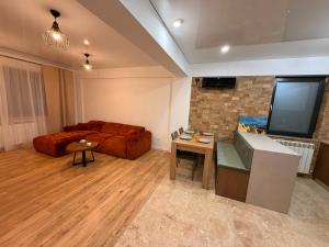 a living room with a couch and a flat screen tv at Livia Residence II in Constanţa