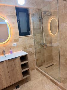 a bathroom with a shower and a sink at Livia Residence II in Constanţa +14 photos