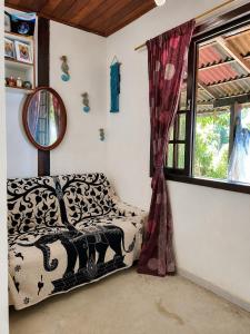 a room with a couch and a window at Casa da Mata Madalena in Angra dos Reis