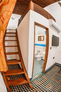 a room with a staircase and a bathroom with a toilet at Riad Noujoum Medina Fez in Fez +61 photos