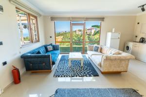 a living room with two couches and a table at Natural Villas Trabzon in Komera