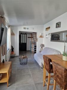 a bedroom with a bed and a table and chairs at Maisonnette à 350m de la plage in Berck-sur-Mer