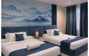 a bedroom with two beds and a mural of mountains at lotus view El tahrir in Cairo