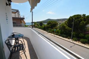 a table on a balcony with a view of a street at Olympian Kavala in Kavála
