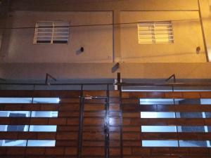 two windows on the side of a building with stairs at Apart Trelew 3 in Trelew
