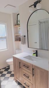 a bathroom with a sink and a mirror at Charming Inner City Home in Calgary +33 photos