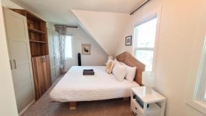 a small bedroom with a bed and a window at Charming Inner City Home in Calgary