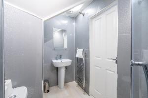 a bathroom with a sink and a toilet and a mirror at The Bitterne Park Hotel in Southampton