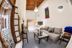 a living room with a couch and a table at Riad Noujoum Medina Fez in Fez