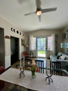 a living room with a table with flowers on it at Isla Verde By The Beach Guest House in San Juan