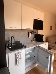 a kitchen with a sink and a counter top at La parenthèse boisée in La Chapelle-en-Serval
