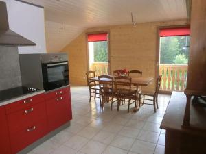 a kitchen and dining room with a table and chairs at gite des granges bailly in Les Fourgs