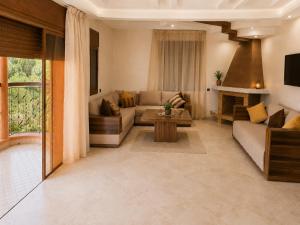 a living room with a couch and a table at Villa des Perles in Marrakesh