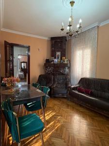 a living room with a table and a couch at Dream House in Batumi