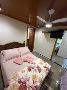 a bedroom with a bed with two bows on it at Recanto Pin in Alfredo Chaves