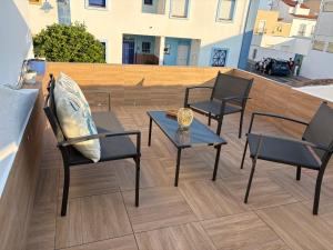 a patio with two chairs and a table and two chairs at Palmera in Isla del Moral