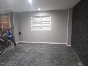 a room with a window and a motorcycle in it at Apart Trelew in Trelew