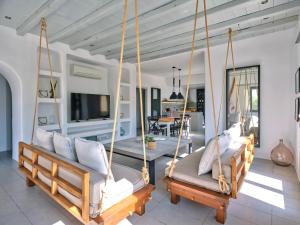 a room with two swinging beds in a house at SeaSalt Dream Villa,Santa Maria 5 min from Naousa in Santa Marina