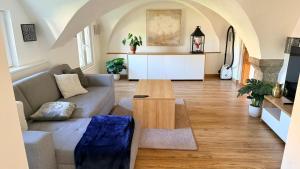 a living room with a couch and a table at Villa d'Aneta in Le Poët