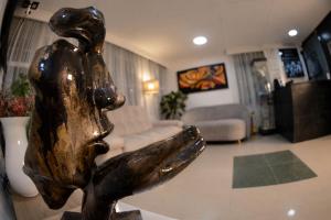 a statue of a woman in a living room at Casa Hotel Estancia Bogota in Bogotá
