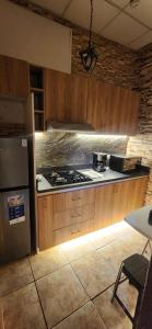 a kitchen with a stove and a refrigerator at Lima Centro Apartment 3 in Lima