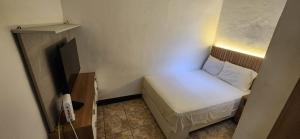 a small bedroom with a small bed in a small room at Lima Centro Apartment 3 in Lima