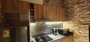 a kitchen with a refrigerator and a stove top oven at Lima Centro Apartment 3 in Lima +2 photos