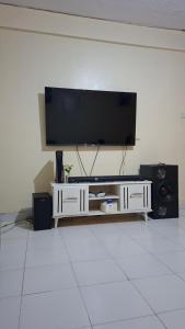 a living room with a flat screen tv on a wall at Boston apartments in Kakamega
