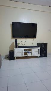 a living room with a flat screen tv on a wall at Boston apartments in Kakamega