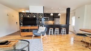 a living room with a television and a table and chairs at Charming Inner City Home in Calgary
