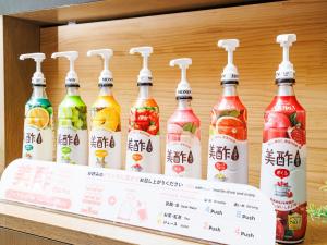 a group of bottles of korean drinks on a shelf at Anshin oyado Tokyo Woman Shinjuku Ogikubo in Tokyo +62 photos