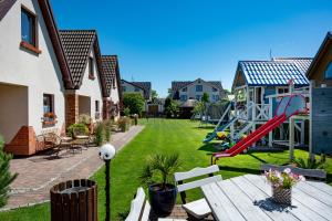 a backyard with a playground with a table and a slide at Pokoje Oaza Spokoju in Nowęcin