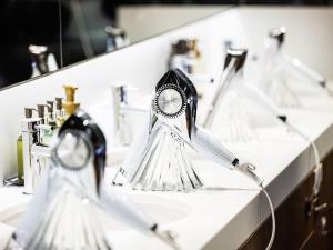 a row of three sinks with chrome faucets at Anshin oyado Tokyo Woman Shinjuku Ogikubo in Tokyo