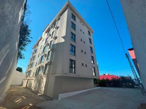 a tall white building with a lot of windows at Atlas Suite Trabzon in Trabzon