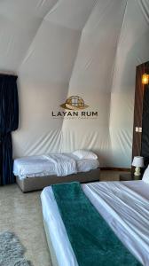 a room with two beds in a tent at LAYAN RUM LUXURY CAMP & Jeep Tours in Wadi Rum +43 photos
