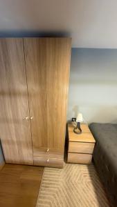 a bedroom with a wooden cabinet next to a bed at Matosinhos Urban Loft in Matosinhos