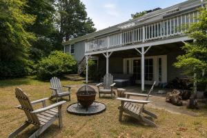 a group of chairs sitting in front of a house at Central AC Game Room Dog-Friendly in Chatham