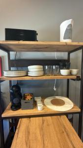 a wooden shelf with plates and dishes on it at Matosinhos Urban Loft in Matosinhos +9 photos
