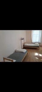 a bedroom with two beds and a window at House in Kyzart