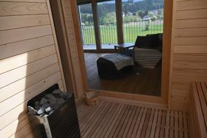 a screened in porch of a cabin with a fireplace at Haus Preber in Mariapfarr
