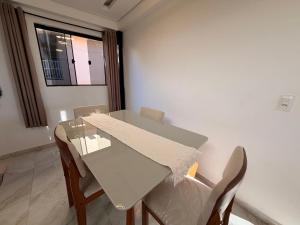 a table and chairs in a room with a window at Pousada Bela Flor in São Thomé das Letras +87 photos