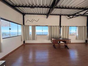 a large room with a ping pong table in it at Pousada Bela Flor in São Thomé das Letras