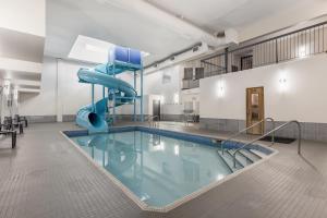 a swimming pool with a slide in a building at Days Inn by Wyndham Valemount in Valemount